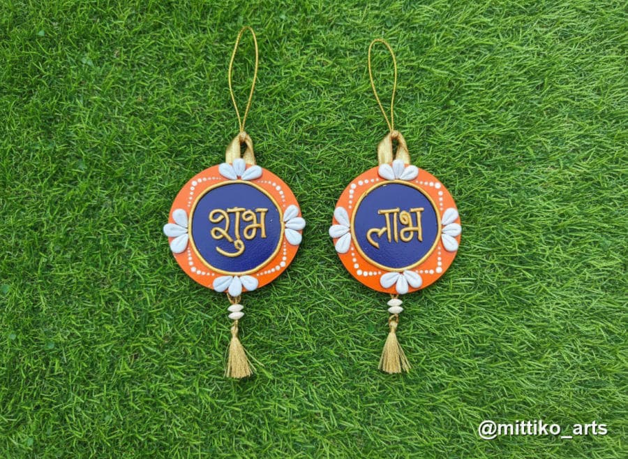 Shubh Labh Cowrie Shell Wall Hangings – Orange & Navy Pair